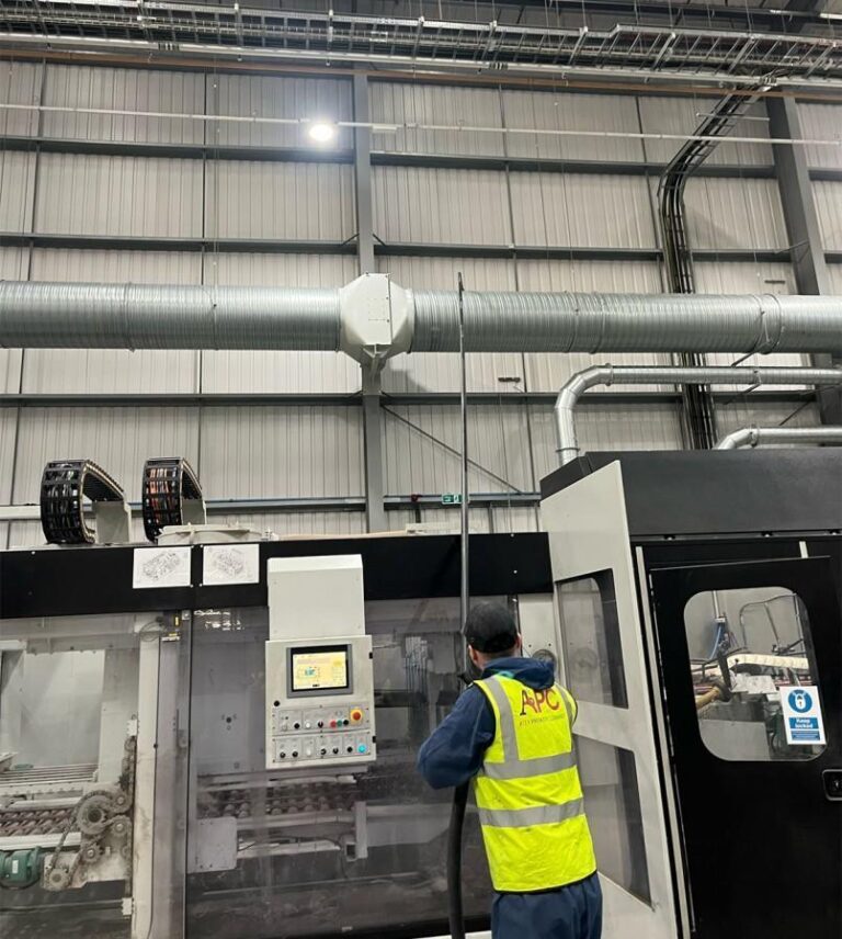 Certified atex cleaning APC technician cleaning high-level ducting above CNC machinery